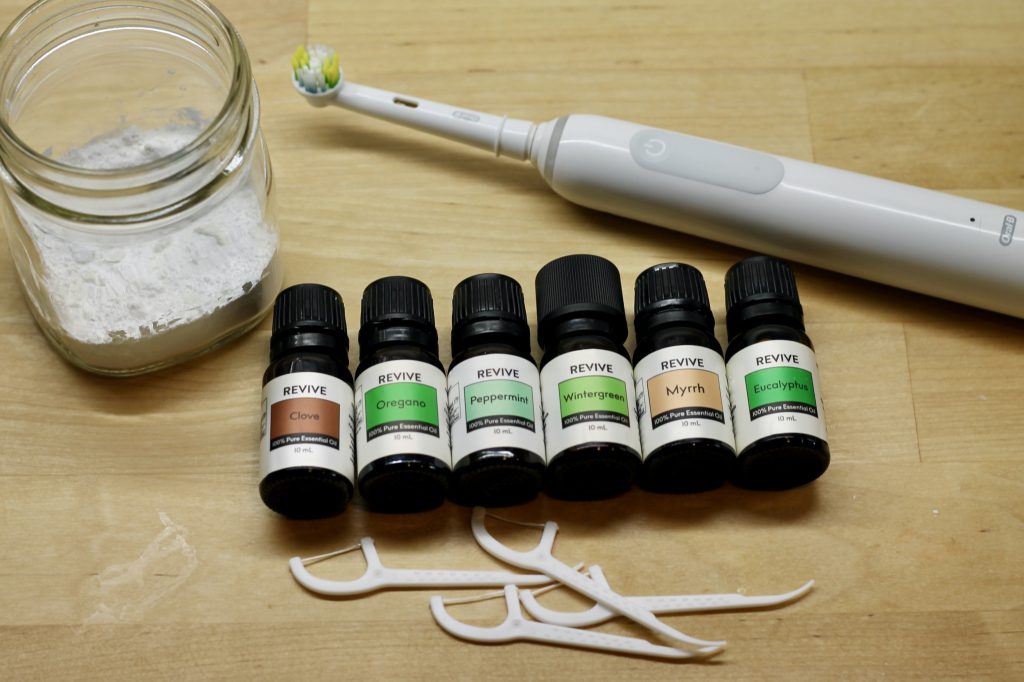 DIY tooth powder with oils, flossers, and toothbrush
