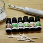 DIY tooth powder with oils, flossers, and toothbrush