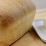 Does Homesteading Save Money? homemade bread next to butter on a dish