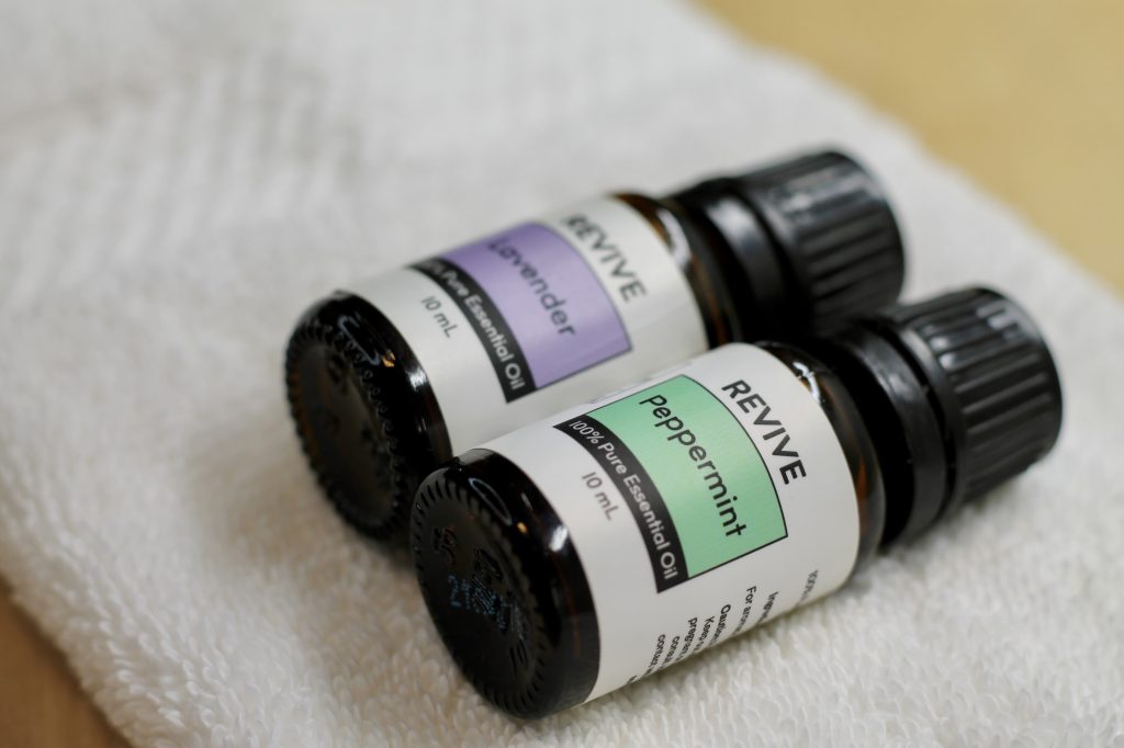 2 bottles of essential oils on a white towel
