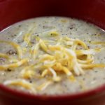 Cheeseburger Soup topped with cheese
