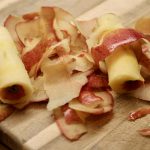 apple peels and a core on a cutting board