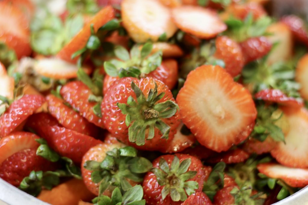 strawberry tops in a bowl of Safe Table Scraps for Chickens