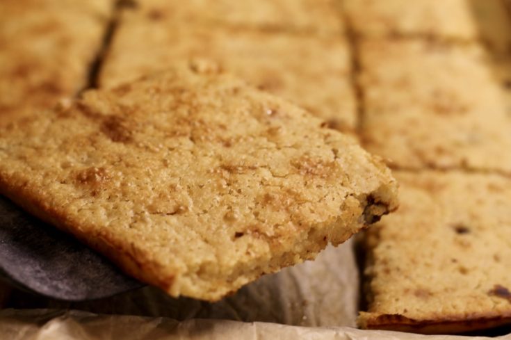 Sourdough Sheet Pan Pancakes sliced and on a spatula