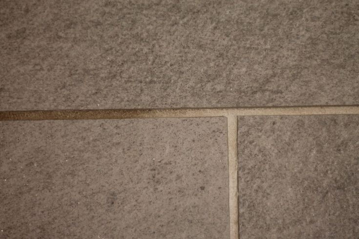 grout that half has been scrubbed with Homemade Grout Cleaner and half has not