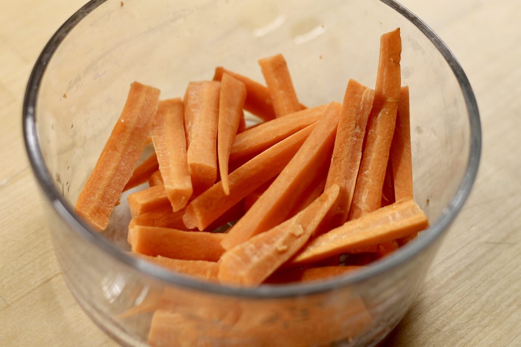 cleaned and cut carrot sticks in a glass bowl